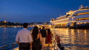 Elegant adult visitors boarding a ferry toward an offshore casino vessel on the Mandovi River in Panaji, goa deltin royal casino at night